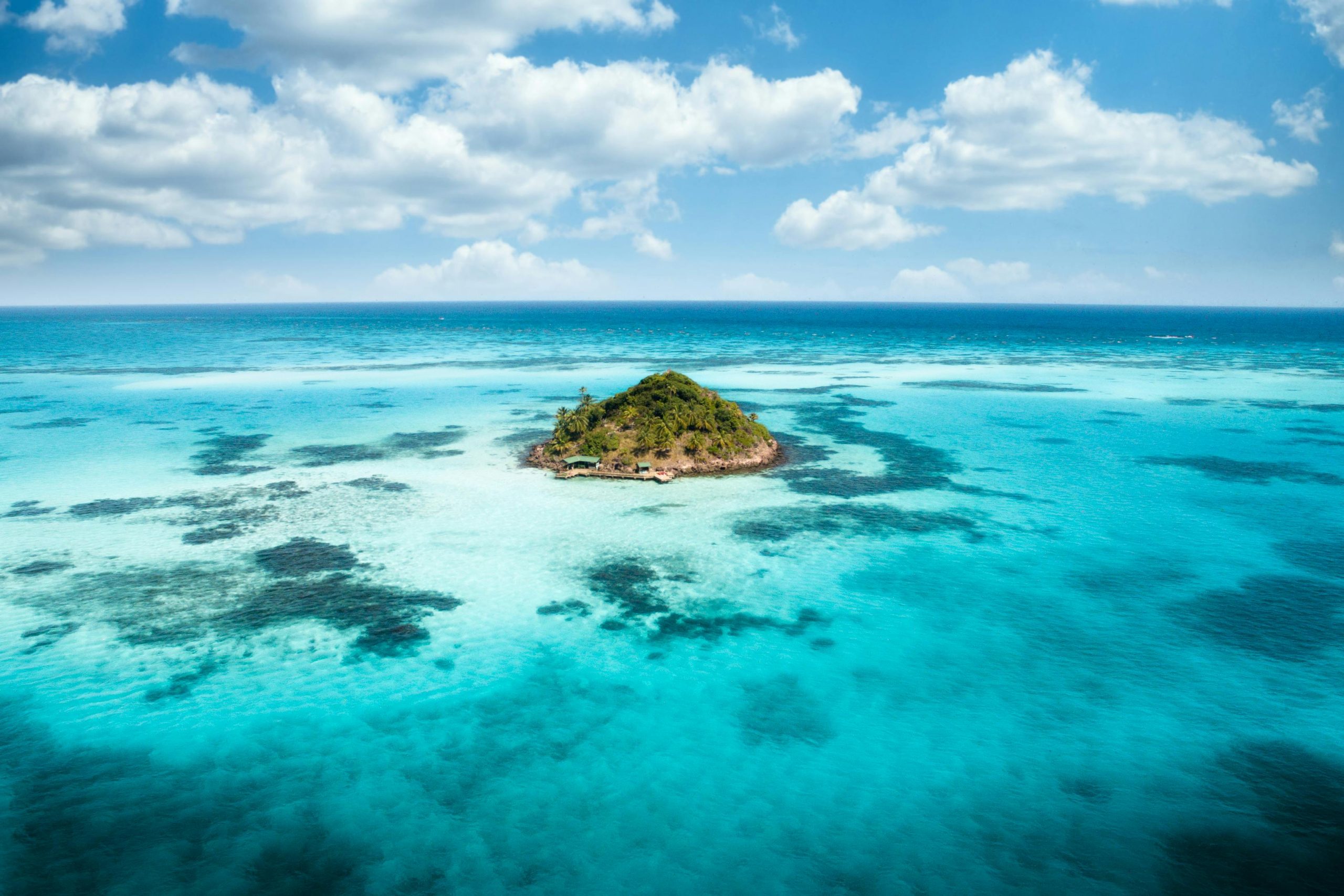 Stunning aerial view of a tropical island surrounded by vibrant turquoise waters off the coast of Colombia.