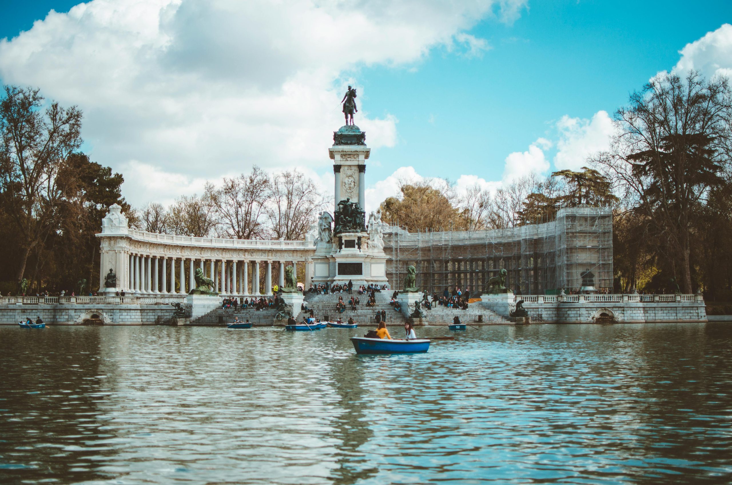 Scenic view of Monument to Alfonso XII, Retiro Park, Madrid, with boating on the lake.