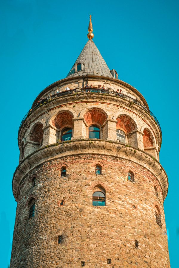 Historical Galata Tower in Istanbul with a scenic view against a cloudless sky.