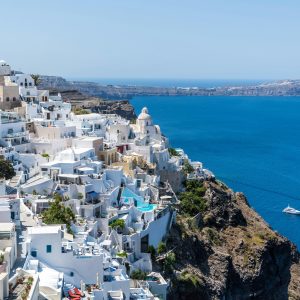 Beautiful Santorini houses overlooking the Aegean Sea on a sunny day.